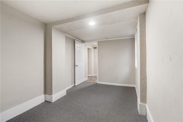 below grade area featuring carpet floors and baseboards