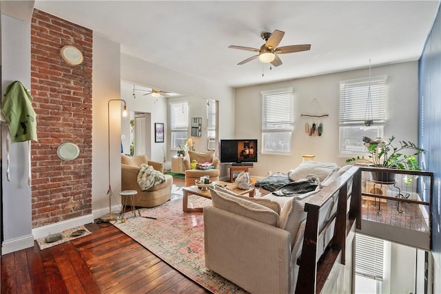 living room featuring a ceiling fan, hardwood / wood-style flooring, and baseboards