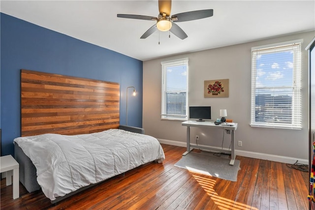 bedroom with ceiling fan, hardwood / wood-style flooring, and baseboards