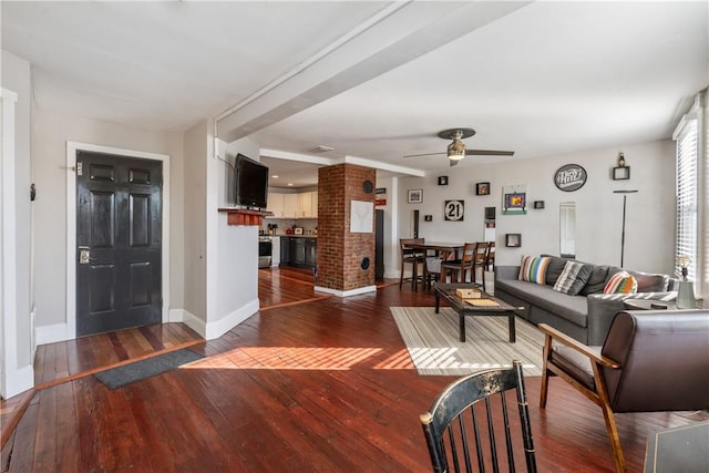 living room featuring hardwood / wood-style flooring, baseboards, and a ceiling fan