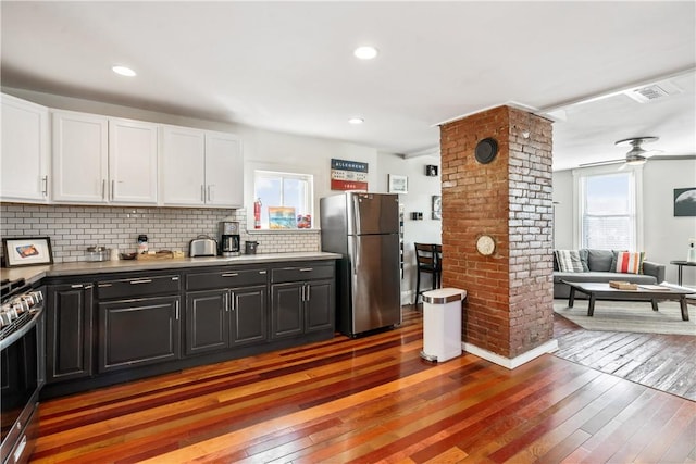 kitchen with visible vents, appliances with stainless steel finishes, white cabinetry, and light wood-style floors