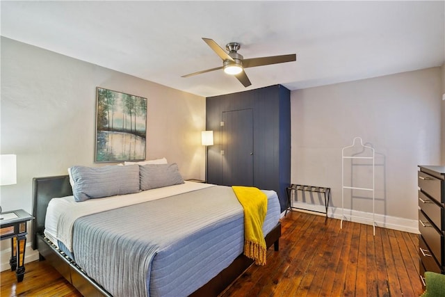 bedroom featuring ceiling fan, hardwood / wood-style floors, and baseboards