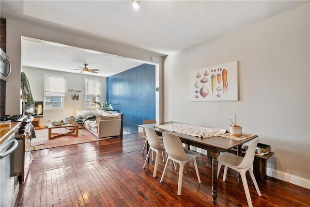 dining area with cooling unit, wood-type flooring, baseboards, and a ceiling fan