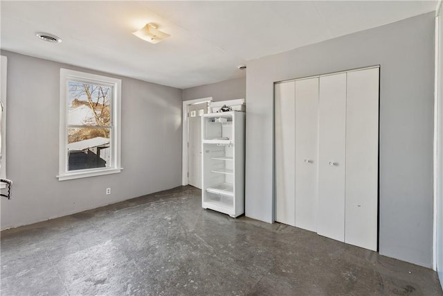 unfurnished bedroom featuring visible vents and a closet