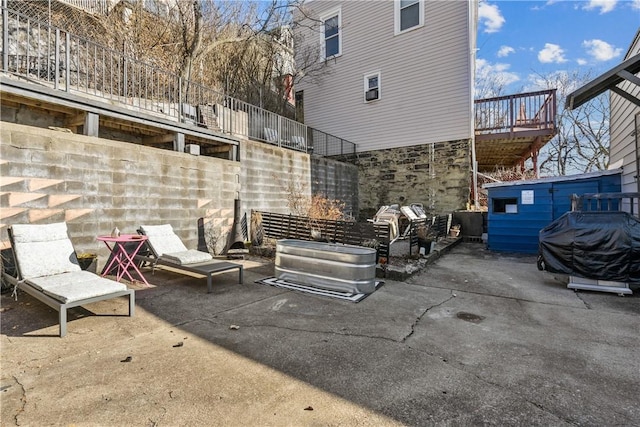 view of patio with a grill and stairway