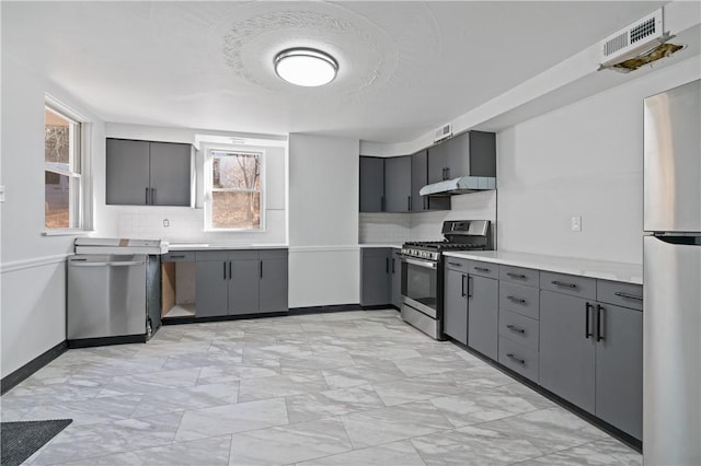 kitchen with visible vents, stainless steel appliances, light countertops, gray cabinetry, and under cabinet range hood