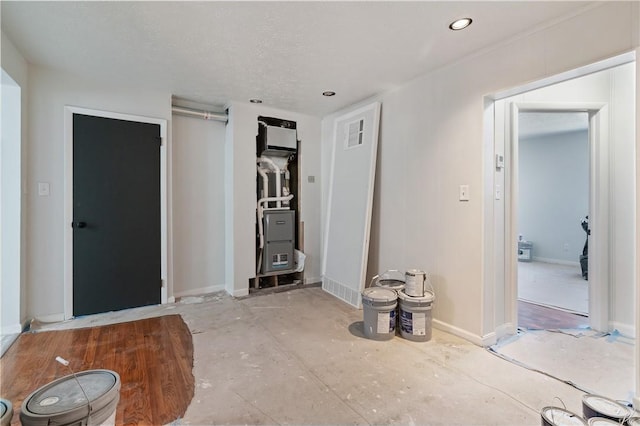 interior space with a closet, recessed lighting, and baseboards