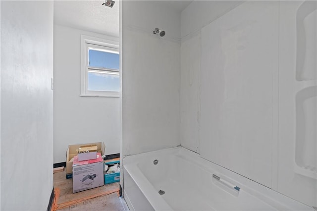 bathroom with a tub, a shower, and a textured ceiling