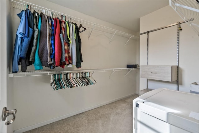 spacious closet featuring carpet floors and independent washer and dryer