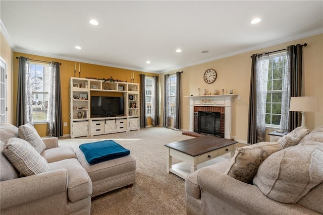 living area featuring a healthy amount of sunlight, a fireplace, and crown molding