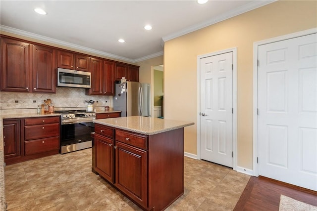 kitchen featuring baseboards, decorative backsplash, light stone counters, appliances with stainless steel finishes, and crown molding