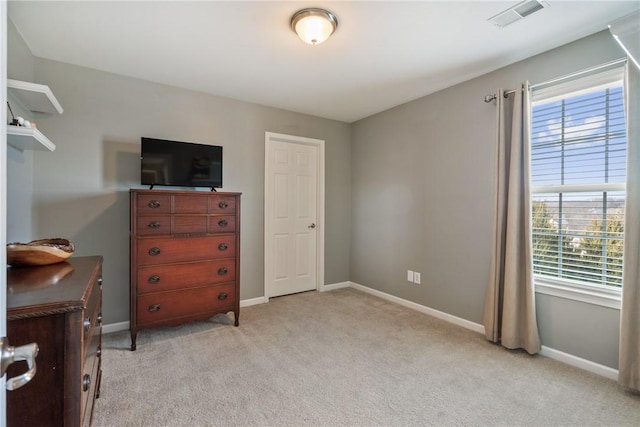 bedroom featuring baseboards, visible vents, and light colored carpet