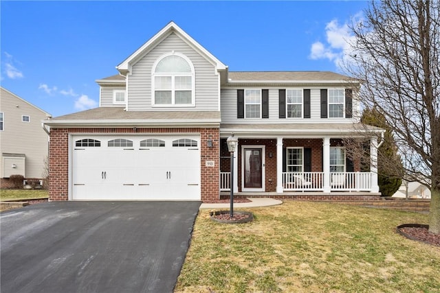 view of front of house with brick siding, aphalt driveway, an attached garage, a porch, and a front yard