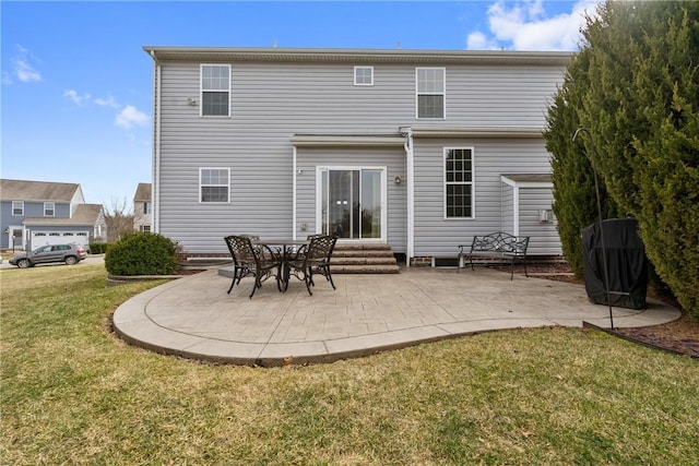 back of property featuring entry steps, a yard, and a patio