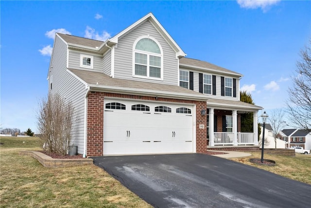 view of front of house featuring aphalt driveway, brick siding, a porch, an attached garage, and a front lawn