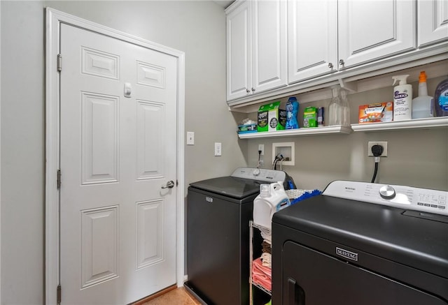 laundry room featuring cabinet space and washer and clothes dryer