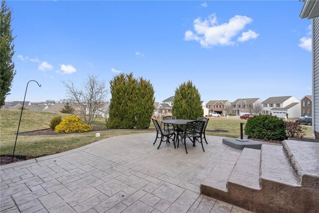 view of patio / terrace with outdoor dining space and a residential view