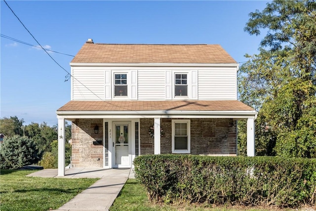 view of front of property with a porch and a front yard