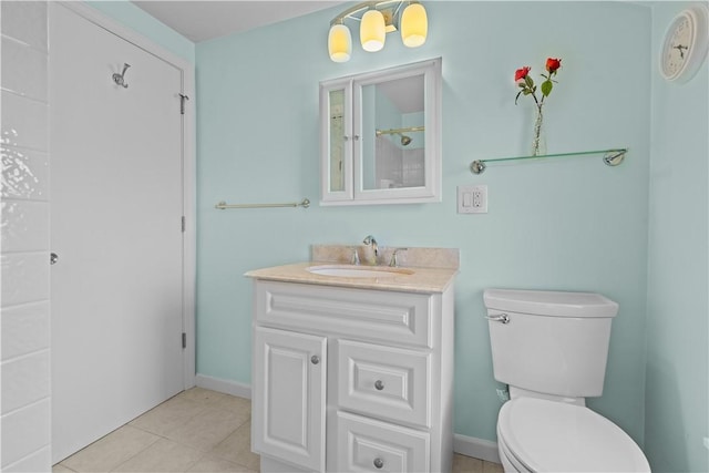 bathroom featuring tile patterned floors, vanity, toilet, and baseboards