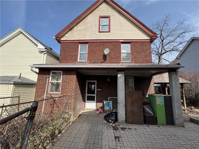 back of house with fence and brick siding