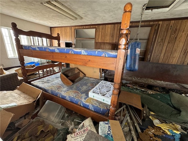 bedroom featuring wood walls