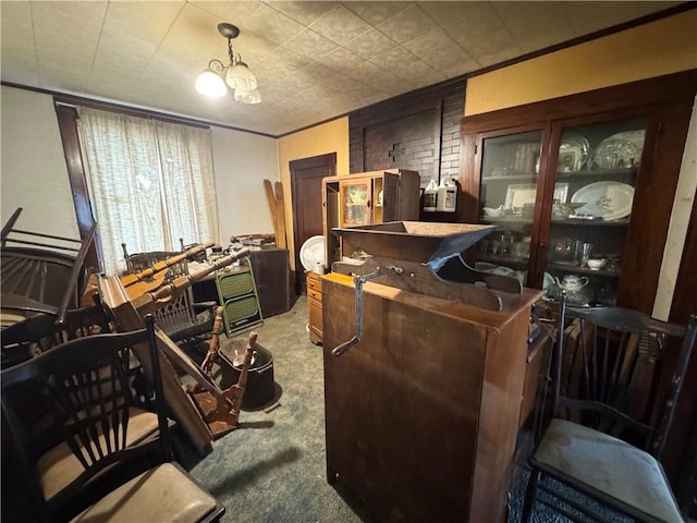 carpeted office featuring a notable chandelier