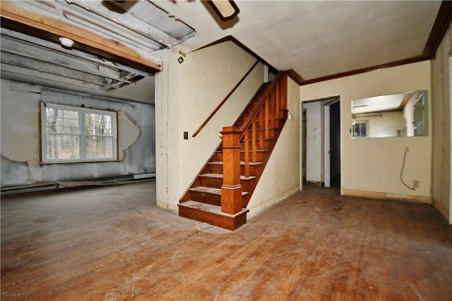 basement with ornamental molding, wood finished floors, and stairs