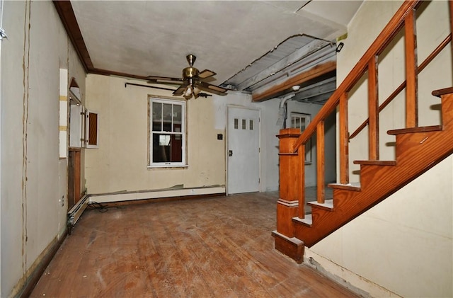 entrance foyer featuring ceiling fan, stairway, a baseboard radiator, and wood finished floors