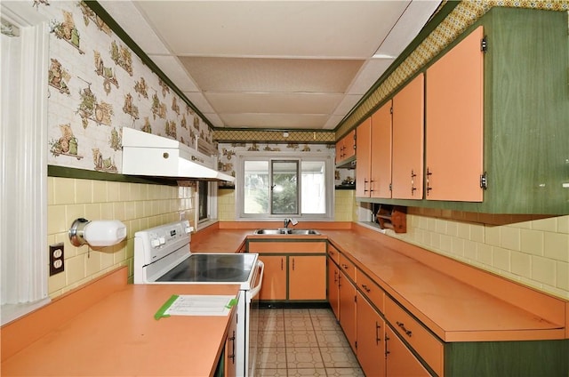 kitchen with white electric range oven, light countertops, wallpapered walls, a sink, and extractor fan