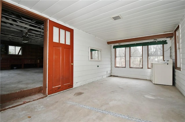 unfurnished sunroom with washer / dryer and a wealth of natural light