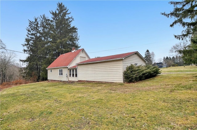 back of house with a lawn