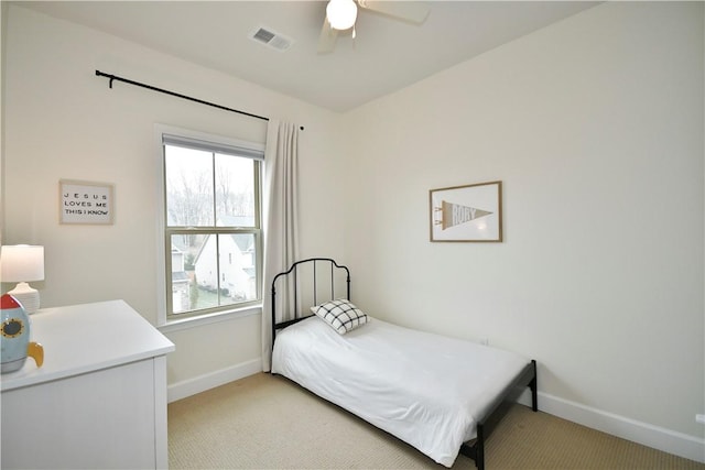 bedroom with light carpet, visible vents, and baseboards