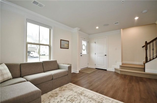 living area with visible vents, stairway, and crown molding