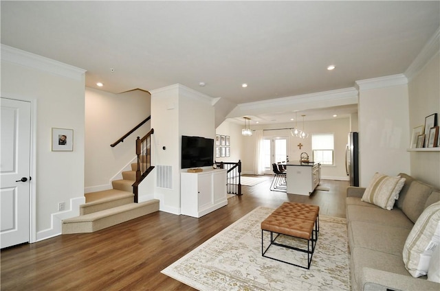 living room with visible vents, dark wood finished floors, stairway, ornamental molding, and recessed lighting