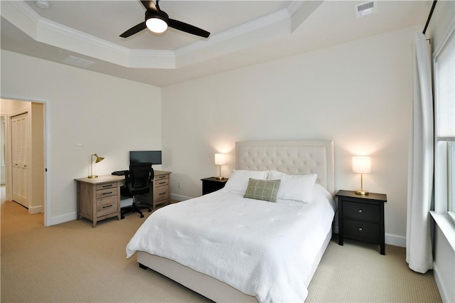 bedroom with light carpet, visible vents, baseboards, ornamental molding, and a raised ceiling