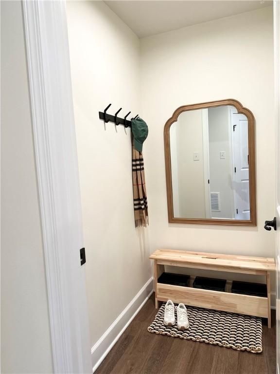 mudroom featuring visible vents, baseboards, and wood finished floors