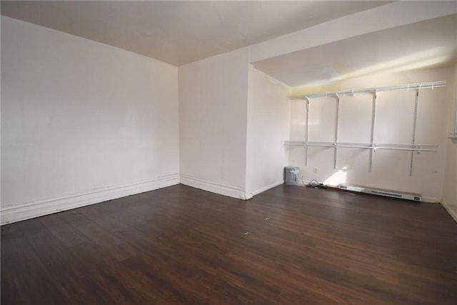 unfurnished room featuring baseboards and wood finished floors