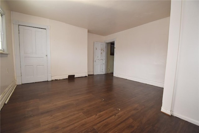 unfurnished bedroom with wood finished floors and baseboards