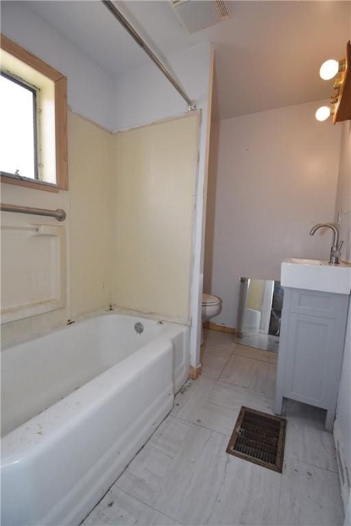 bathroom featuring a bath, vanity, and toilet