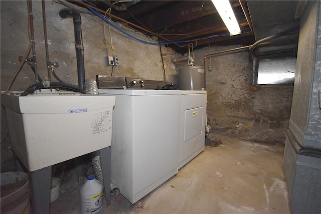 laundry room with laundry area, water heater, a sink, and washer and clothes dryer