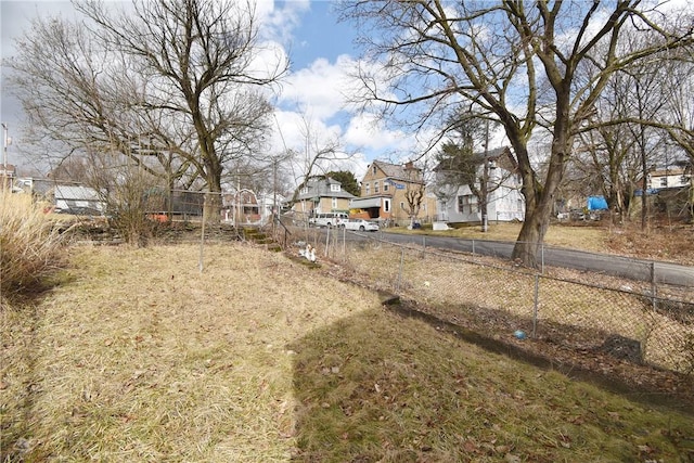 view of yard with a residential view and fence