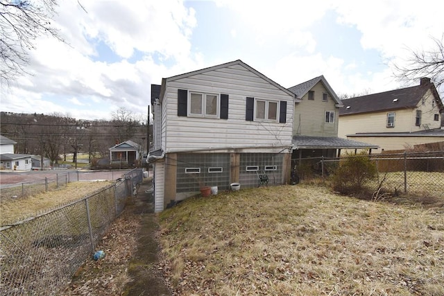 back of house with a fenced backyard