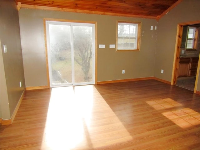 spare room featuring wooden ceiling, baseboards, and wood finished floors