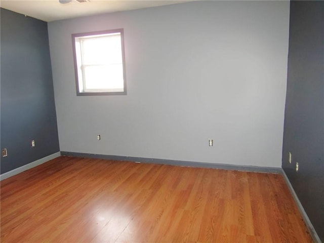 unfurnished room featuring light wood-type flooring and baseboards