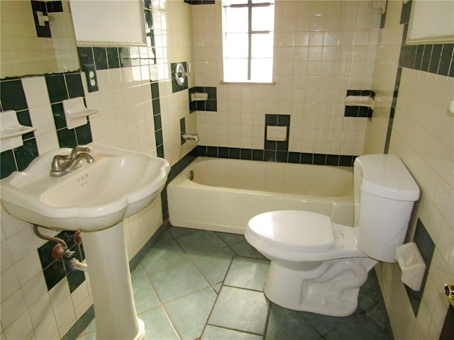 full bathroom featuring toilet, bathtub / shower combination, tile walls, and tile patterned floors