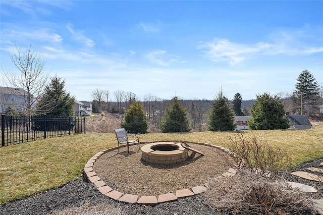 view of yard featuring a fire pit and fence