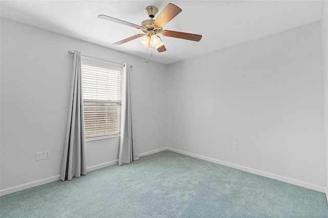 empty room featuring light carpet, a ceiling fan, and baseboards