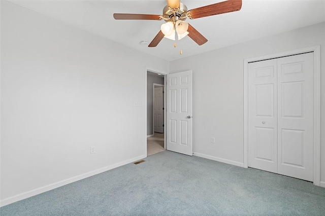 unfurnished bedroom featuring a closet, carpet flooring, visible vents, and baseboards