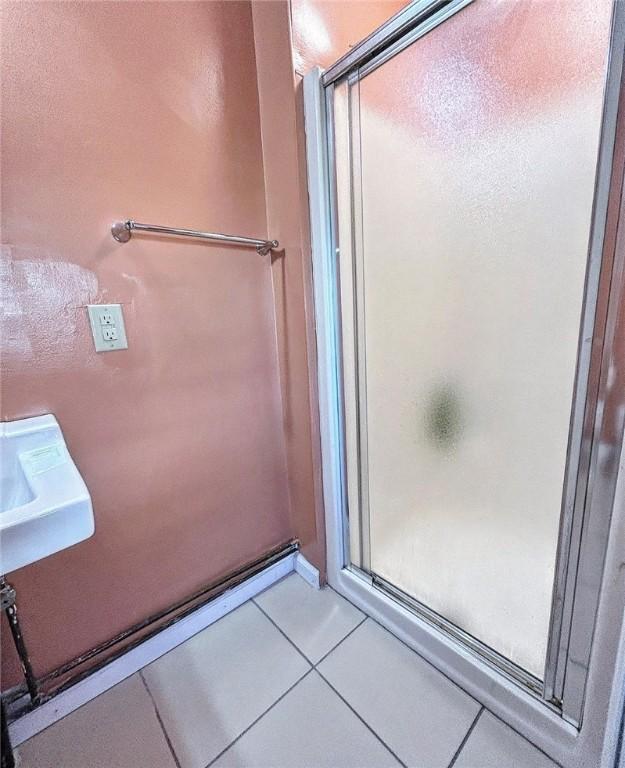 bathroom featuring a stall shower and tile patterned flooring