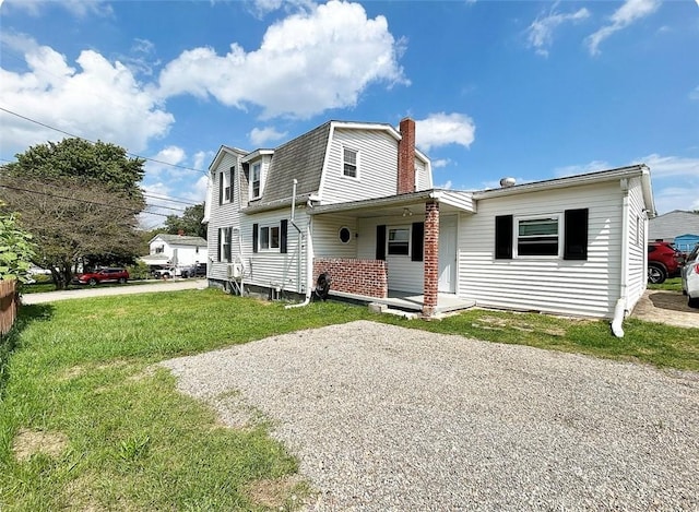 view of front of property with a gambrel roof, a chimney, roof with shingles, gravel driveway, and a front yard